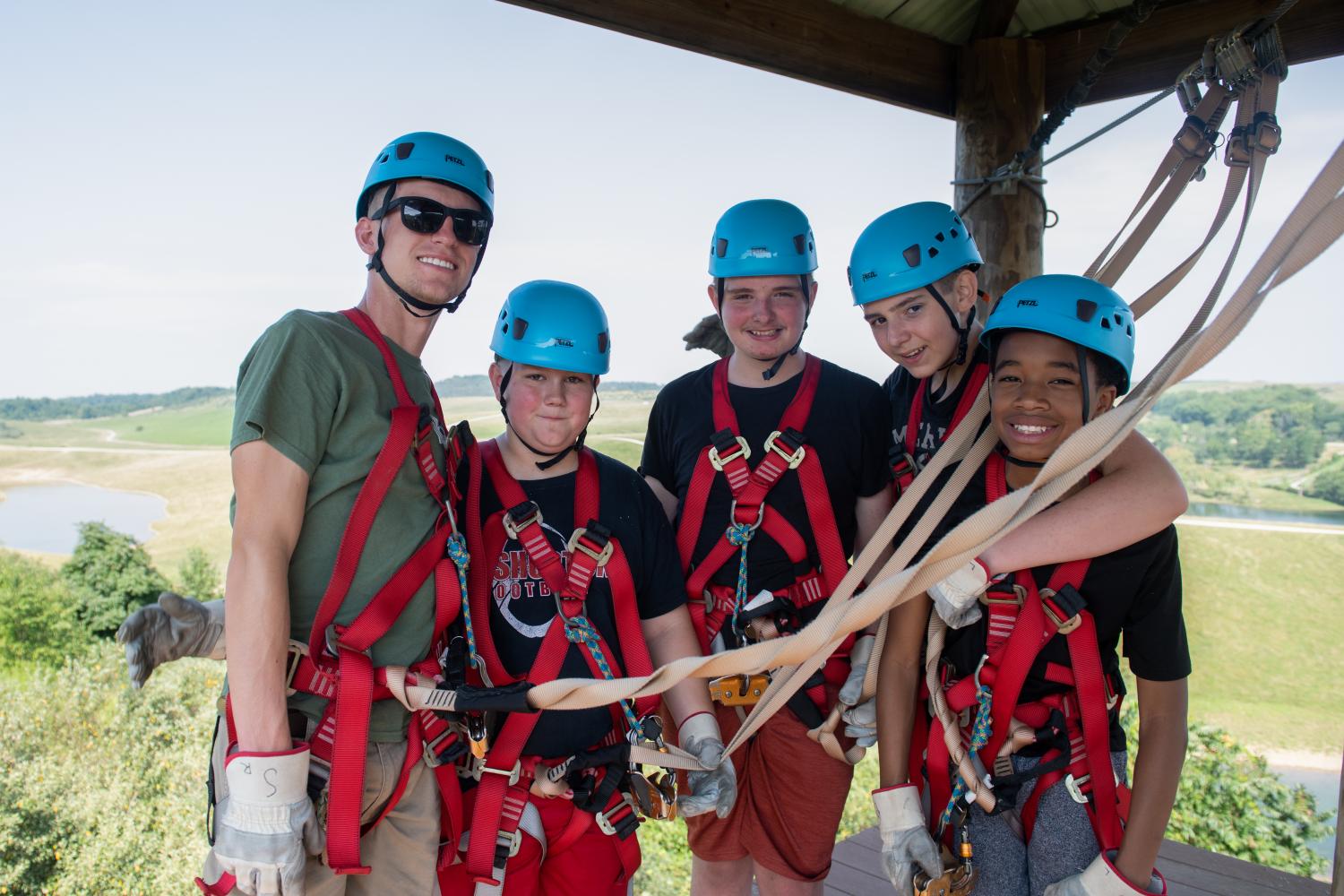 Adventure camp counselor zip-lining with camp