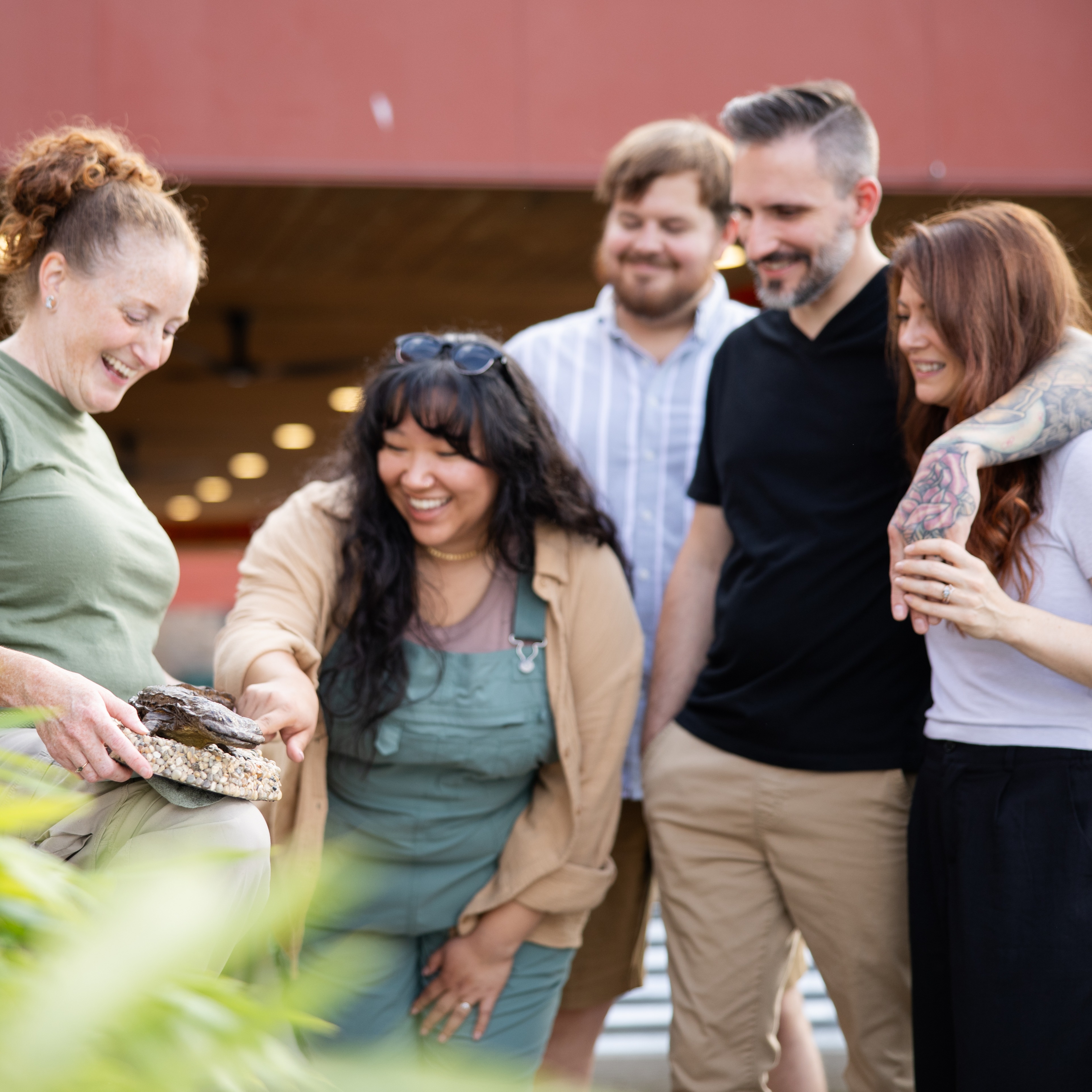 guests at The Wilds looking at hellbender mockup