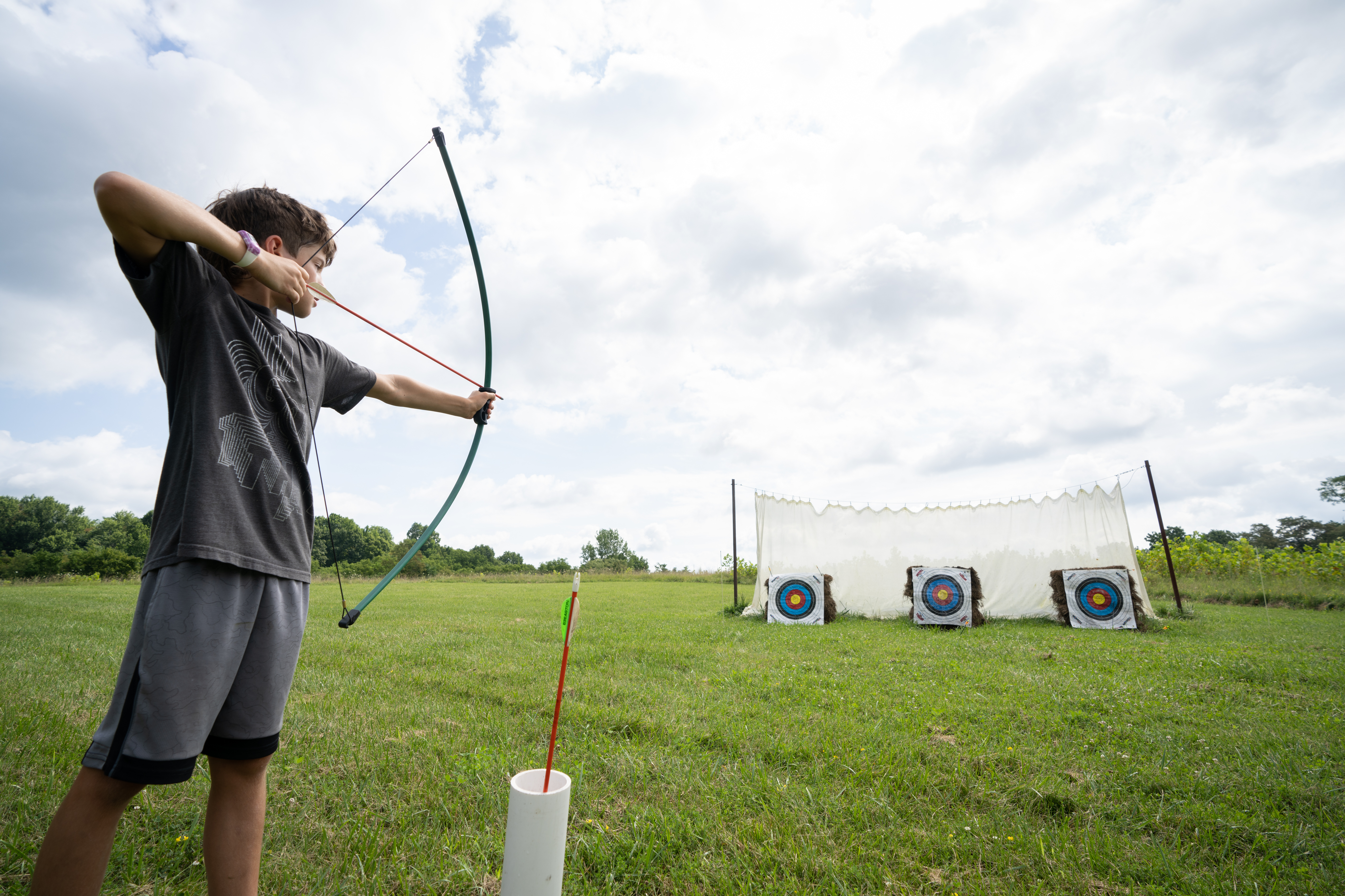 child with bow and arrow