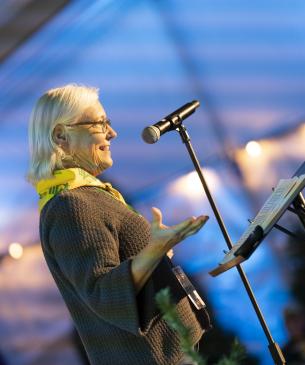 Speaker addressing an audience on a stage
