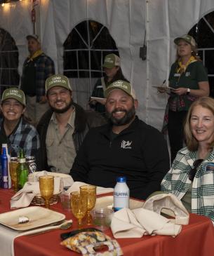 guests posing for a picture sitting at a table